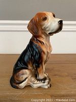 Side view of ceramic beagle dog figurine showing color and texture details