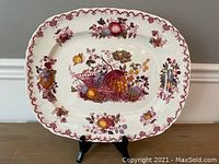 Full view of Mason's Ironstone platter with fruit basket decoration on display stand