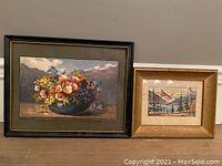 Both watercolor paintings framed side by side on wall.