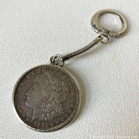 Obverse side of 1921 Morgan silver dollar coin keychain showing Lady Liberty's profile with date 1921 and 'E PLURIBUS UNUM' inscription.