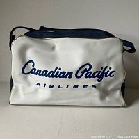 Front view of the vintage airline bag showing the Canadian Pacific Airlines logo in blue on a white background.