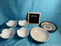 Photo of all six bowls including four white tulip-shaped Pier 1 bowls, one plain grey bowl, and one blue trim ceramic bowl with circular design.