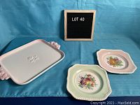 Photo showing white ironstone serving platter with pink floral handles and center embossed floral design alongside two Johnson Brothers luncheon plates with fruit and floral patterns.