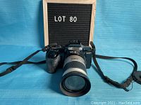 Front view of Minolta Maxxum 5000i camera with zoom lens attached, showing camera body and lens details