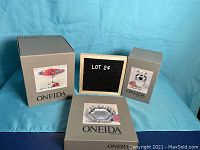 Set of three boxed Oneida silver plate items: compote, bouquet vase, and round bowl
