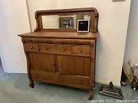 Front view of Tiger Oak sideboard buffet with mirror and drawers