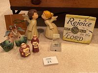 All angel and religious themed items including figurines and plaque arranged together