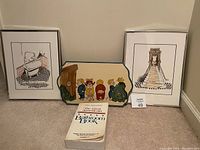 Photo of entire bathroom décor lot showing two framed pictures, one wall plaque, and one book