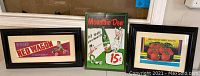 Shows the three items together: two framed advertising prints and one metal Mountain Dew sign.