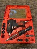 Tools and sockets in red carrying case with clear lid showing contents