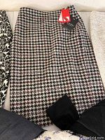 Close-up of wool houndstooth skirt with tags attached.