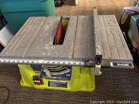 Top view of Ryobi 10 inch table saw metal surface showing the saw blade and extension table