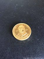 Front side of brass medal showing engraved portrait of Senator Robert F. Kennedy with dates 1925 and 1968.