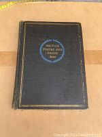 Front cover view of the book showing title and blue laurel wreath design