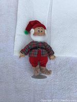 Front view of Happy dwarf figure wearing Christmas-themed clothing and hat, showing face and upper body with stand.