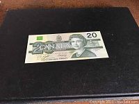 Front of 1991 Canadian $20 bill with Queen Elizabeth II, serial number, and denomination details.