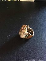 Frog rhinestone ring showing front angled view highlighting rhinestones and faux ruby eyes.