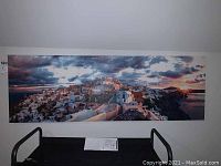 Full view of the panoramic canvas print showing the village and cloudy sky at sunset or sunrise.