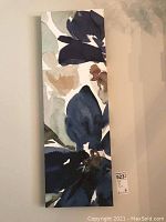 First floral fabric wall art panel featuring abstract large blue and neutral-toned flowers.