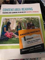 Close-up photo of the book titled 'Content Area Reading: Teaching and Learning in an Age of Multiple Literacies' showing front cover with Amazon Rentals sticker.