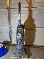 Full upright view of Hoover FloorMate hard floor cleaner showing the handle, tank, and cleaning base.