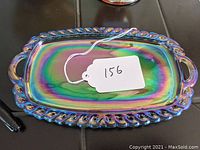 Top view of the amethyst carnival glass pin tray showing its iridescent colors and rope border design