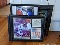 Three framed Boston sports memorabilia items including Tom Brady Super Bowl collage, Red Sox catcher photo, and Celtics plaque.