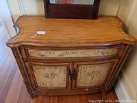 Overall photo of the wooden buffet cabinet showing top, drawer and doors.