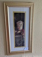 Full view of the framed print showing urn and floral elements, gold frame and matting.