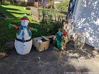 Full group showing large snowman figure, wireframe reindeer, other decorations, and box of parts.