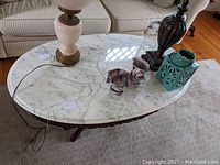 Overhead view of oval marble top showing surface pattern and condition