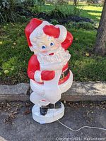 Front view of Santa Claus blow mold in red and white holiday colors with a power cord at the base