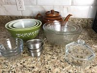 Full lot showing all bowls, teapot, and glassware on countertop.