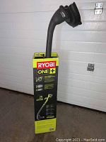 Ryobi One+ branded box containing the string trimmer/edger unit standing upright