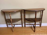 Photo of two half moon wooden side tables, different leg styles, positioned side by side.