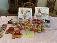 Overview of all ornaments including glass balls, wooden shapes, and angel sets in trays