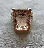 Front view showing large square faceted pastel pink quartz stone set in sterling silver band with prong setting.