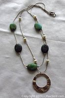 Full view of double strand sterling silver necklace with turquoise beads, freshwater pearls and hammered circle pendant.