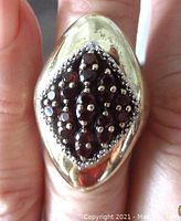Top view showing the lozenge design with multiple garnet stones clustered together surrounded by silver bead accents.