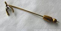 Wish bone shaped stickpin, yellow gold with seed pearl detail shown from angle.