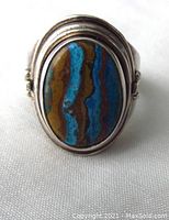 Front view showing the oval calcsilica stone and silver bezel setting with concentric ring decoration.