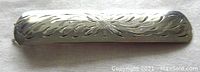 Top view showing engraved floral and leaf pattern on silver barrette