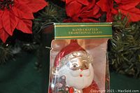Front view of one Jolly Santa Claus Christmas ornament in original unopened green box with window display showing the Santa figure inside