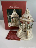 Porcelain musical gazebo with original box and info card, showcasing the front view of the item