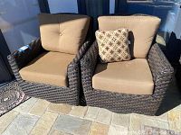 Front view of both wicker chairs with cushions side by side