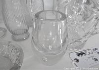 Close-up of small smooth clear glass vase and floral ashtray with Brody Co mark showing good condition and transparency.