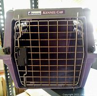Medium purple plastic pet carrier with metal front door showing label 'Petmate Kennel Cab'