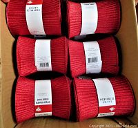 Six rolls of Celebrate It red spiral ribbon, each 5 inches by 15 feet.