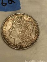 Close-up view of obverse side of 1881 silver dollar showing Lady Liberty head and date with toned patina.