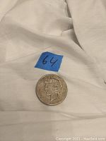 1922 S Peace silver dollar coin on white cloth with blue tape number 64